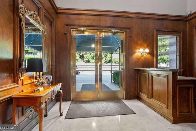 doorway to outside with wood walls and ornamental molding