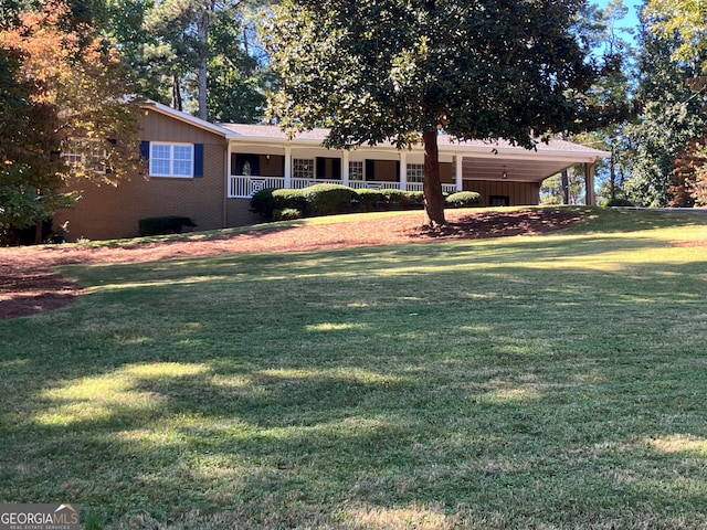 view of yard featuring a porch and an attached carport