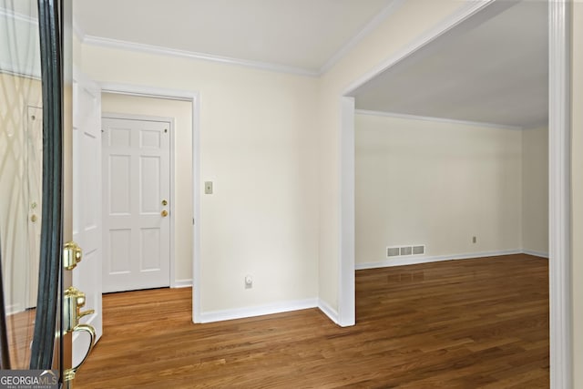 interior space featuring ornamental molding and hardwood / wood-style floors