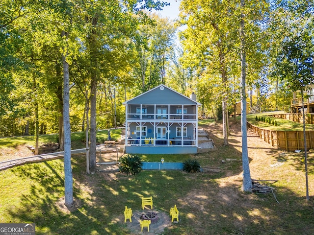 rear view of house featuring a lawn