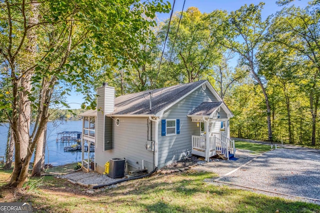 exterior space with a water view and central AC unit