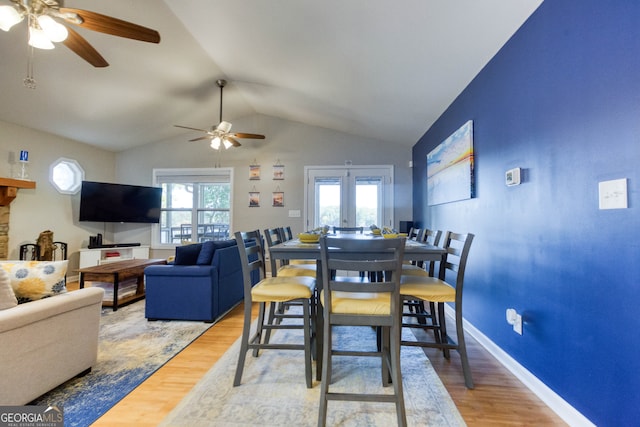 dining room with lofted ceiling, wood-type flooring, and ceiling fan