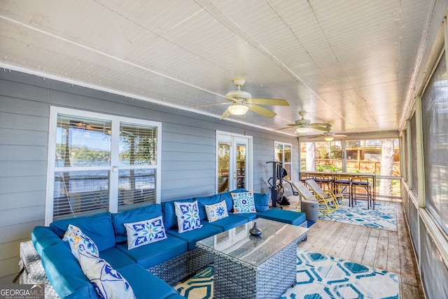 sunroom / solarium featuring ceiling fan