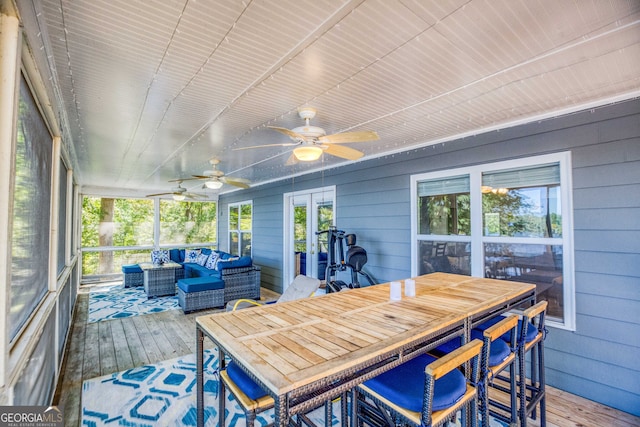 sunroom / solarium featuring ceiling fan