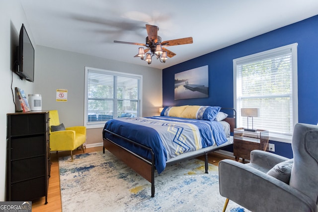 bedroom with light hardwood / wood-style flooring and ceiling fan