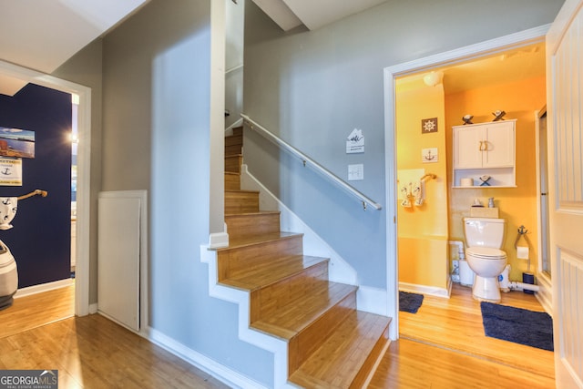 stairway with hardwood / wood-style flooring