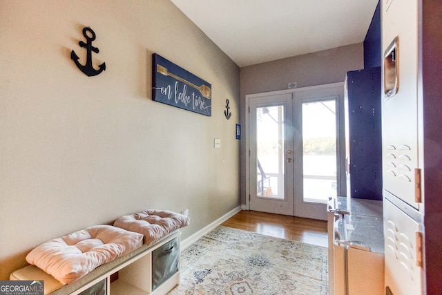 doorway with french doors and light hardwood / wood-style floors