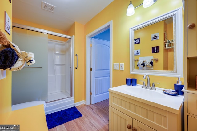 bathroom featuring vanity, hardwood / wood-style floors, and an enclosed shower