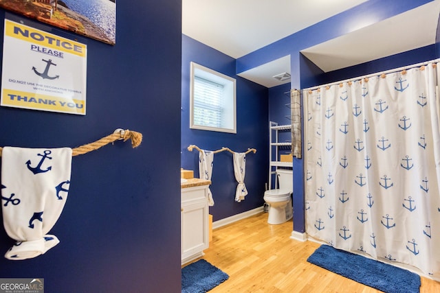 bathroom with vanity, toilet, wood-type flooring, and a shower with shower curtain