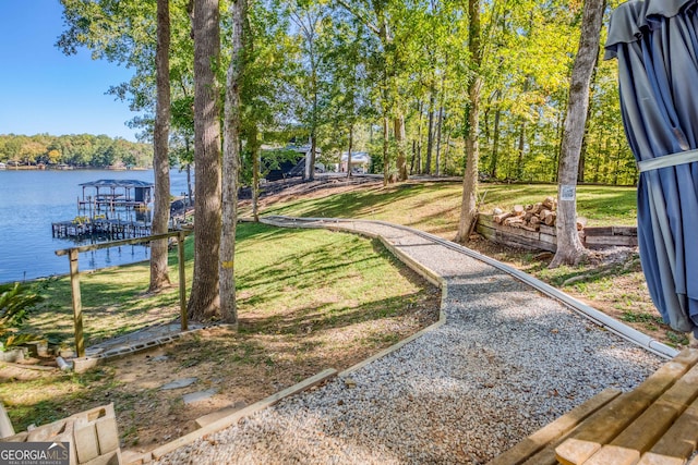 view of yard featuring a water view and a boat dock