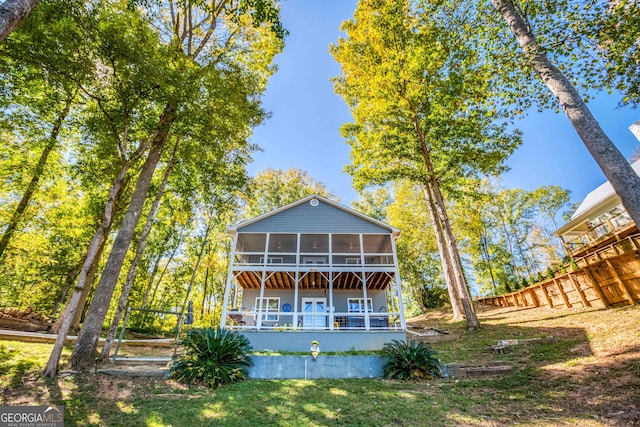 rear view of property with a sunroom