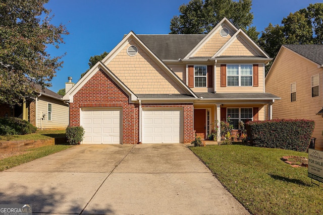 view of front of home featuring a front yard and a garage