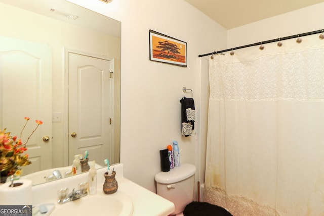 bathroom featuring toilet and sink