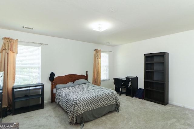 bedroom featuring light carpet