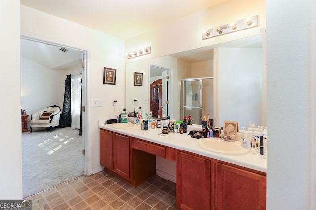 bathroom with vanity and a shower with door