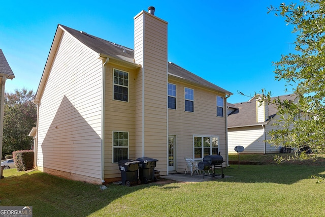 rear view of house featuring a patio area and a lawn