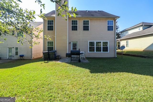 rear view of property with a yard and a patio area