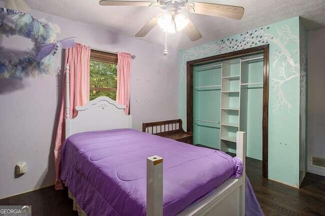 bedroom featuring dark hardwood / wood-style flooring, a closet, and ceiling fan