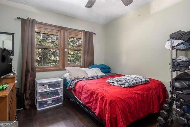 bedroom featuring ceiling fan and dark wood-type flooring