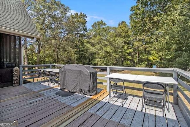 wooden terrace featuring a grill