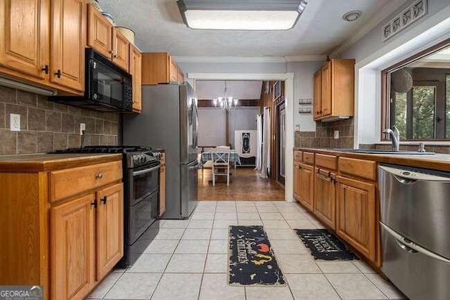 kitchen featuring black appliances, light tile patterned flooring, crown molding, and sink