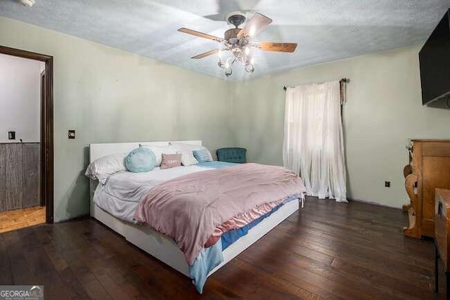 bedroom with ceiling fan and dark wood-type flooring