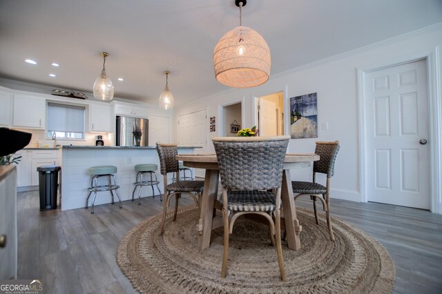 kitchen featuring light hardwood / wood-style flooring, stainless steel appliances, wine cooler, ornamental molding, and white cabinets