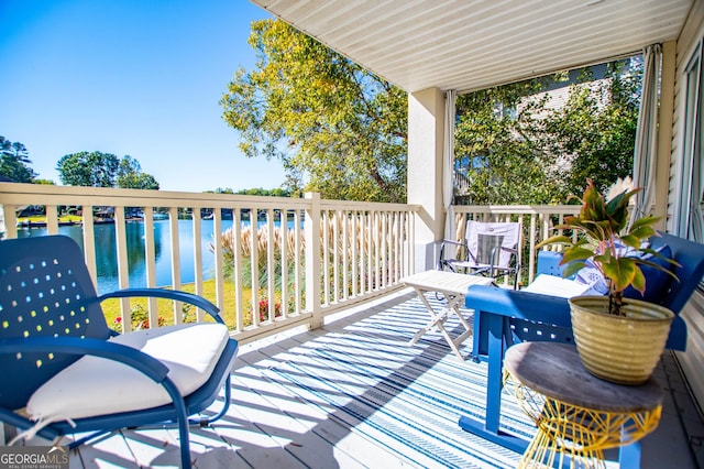 wooden deck featuring a water view