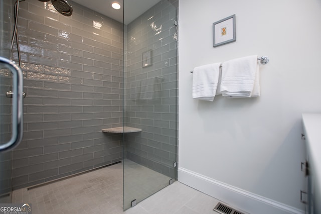 bathroom with tile patterned floors and an enclosed shower