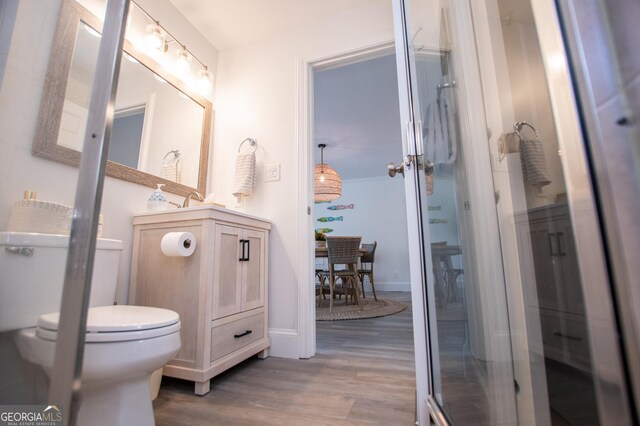 bathroom with a shower with door and sink