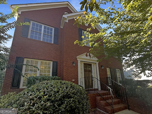 traditional-style house featuring brick siding