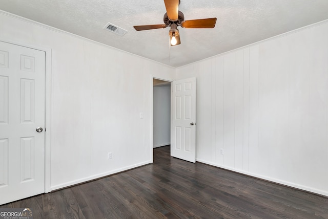 unfurnished room featuring crown molding, dark hardwood / wood-style floors, a textured ceiling, and ceiling fan