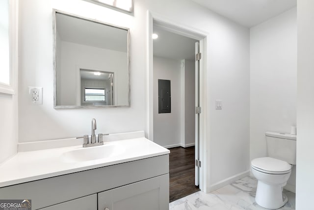 bathroom with vanity, toilet, wood-type flooring, and electric panel