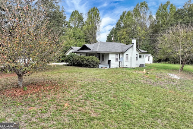 exterior space with covered porch, a front yard, and central AC unit