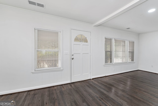 foyer with beam ceiling, ornamental molding, and dark hardwood / wood-style flooring