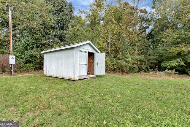 view of outbuilding with a lawn