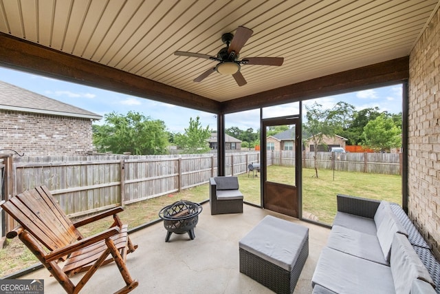 sunroom / solarium featuring wood ceiling and ceiling fan