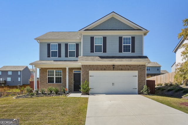 view of front of home featuring a front yard and a garage