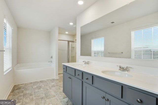 bathroom featuring vanity, independent shower and bath, and plenty of natural light