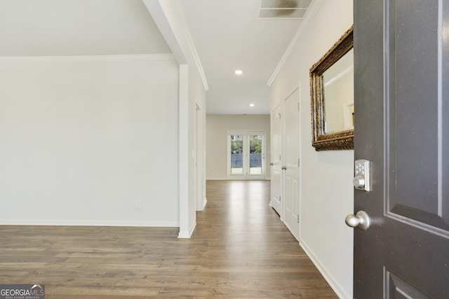 hallway featuring wood-type flooring and ornamental molding