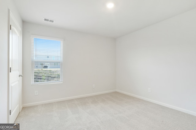 spare room with light colored carpet