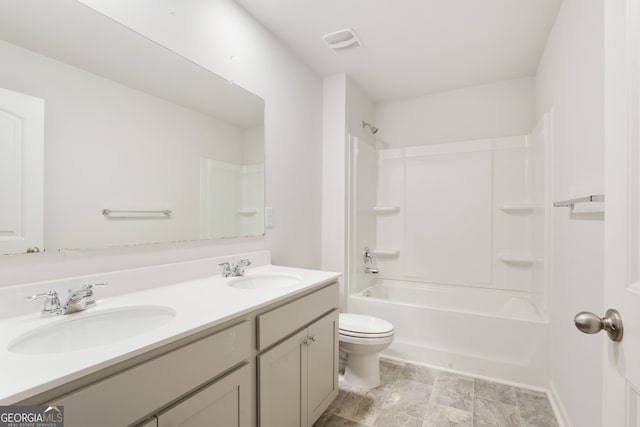 full bathroom with  shower combination, vanity, and toilet