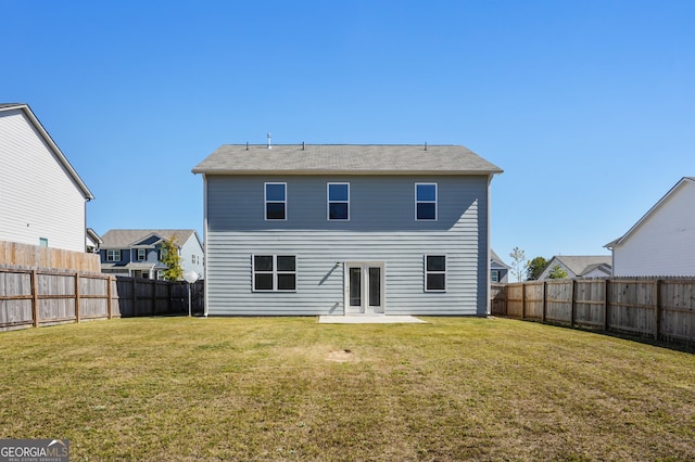 rear view of house with a yard and a patio area