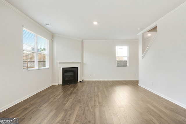 unfurnished living room with crown molding and dark hardwood / wood-style flooring