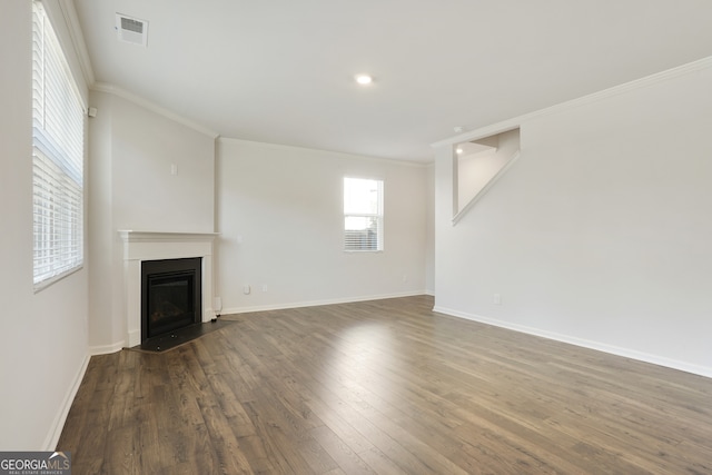 unfurnished living room featuring crown molding and dark hardwood / wood-style floors