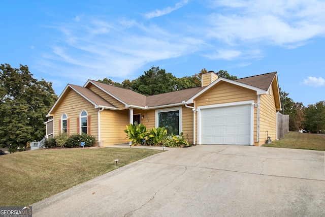 ranch-style house featuring a front yard and a garage