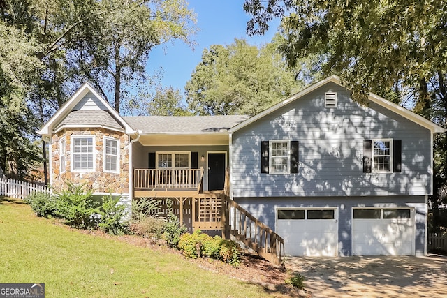 view of front of home with a front yard and a garage