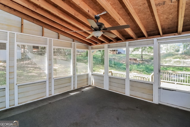 unfurnished sunroom with a wealth of natural light, vaulted ceiling, and ceiling fan