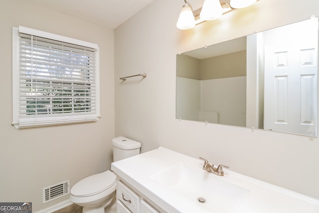 bathroom featuring vanity and toilet