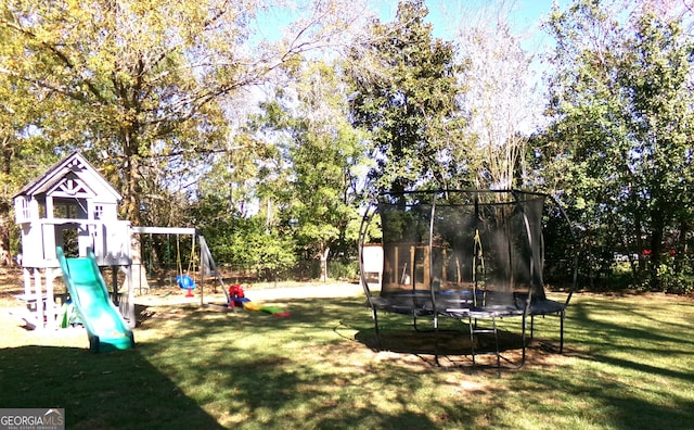 view of yard featuring a trampoline and a playground